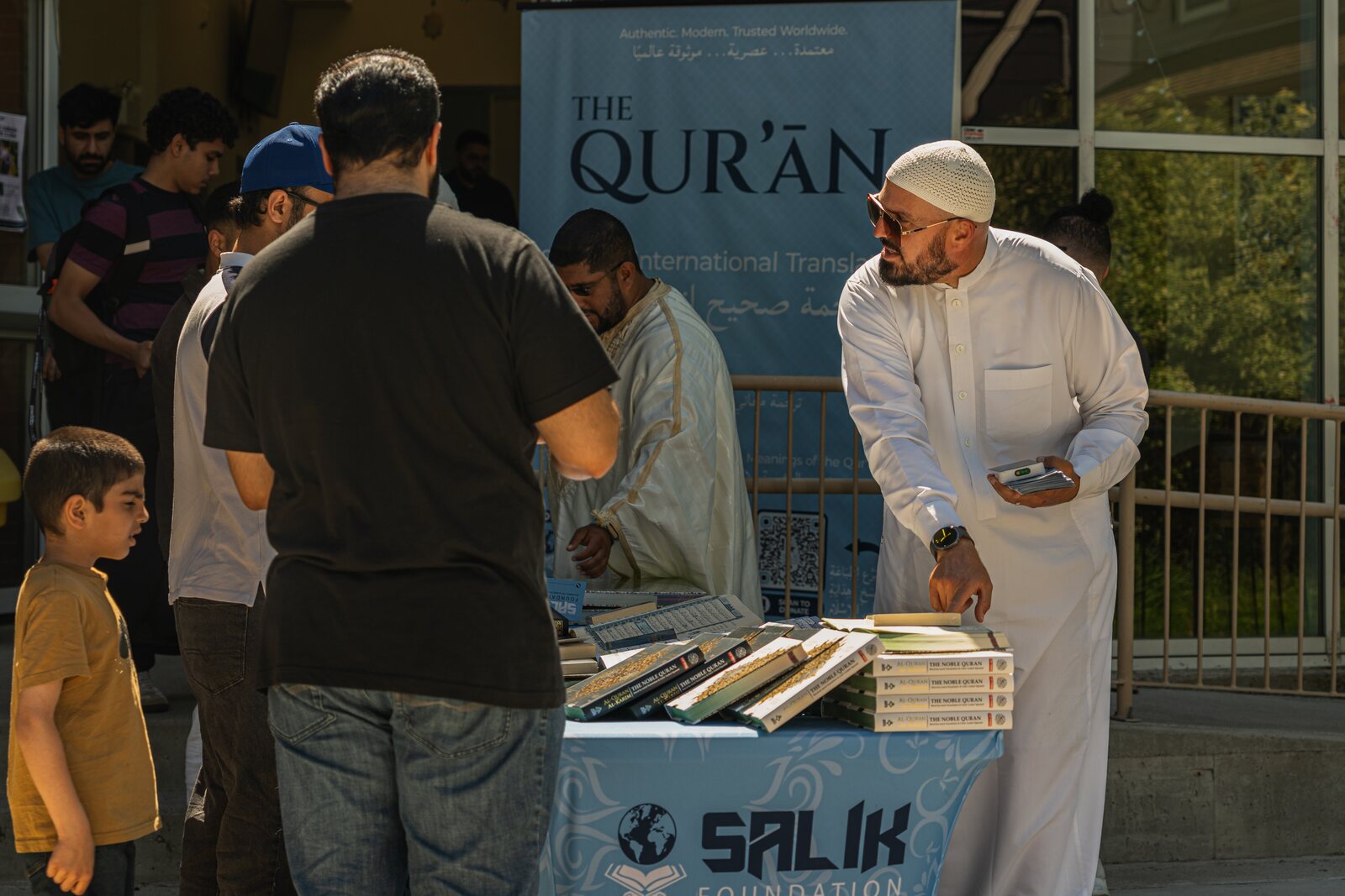 People collecting free Qur'ans from a Salik stand.