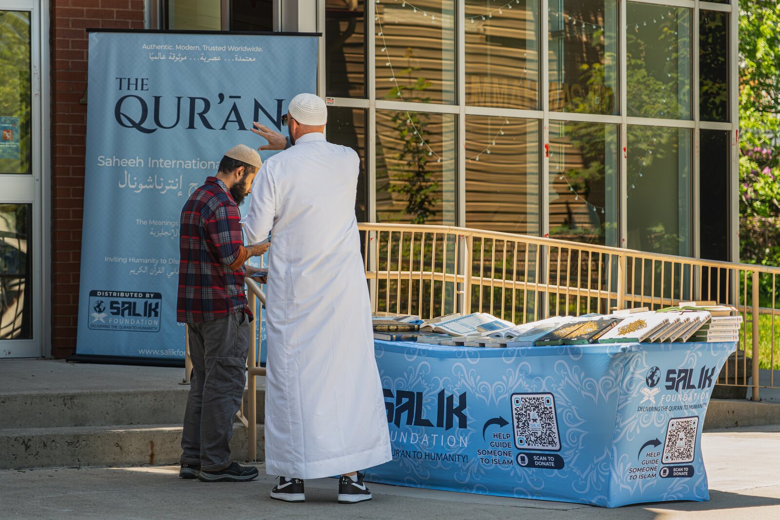 A Salik Foundation Qur'an stand set up in a community.