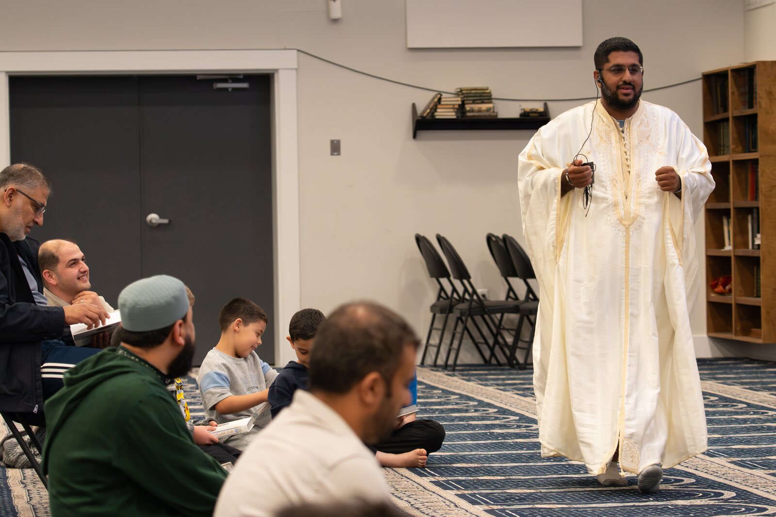 A speaker addressing a gathering in a community room.